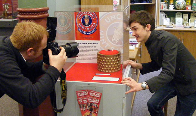Luke Marsden poses with 2 billionth mint ball for cameraman